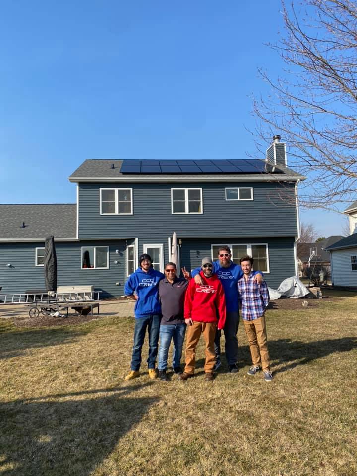 picture of siding contractor team in front of completed home